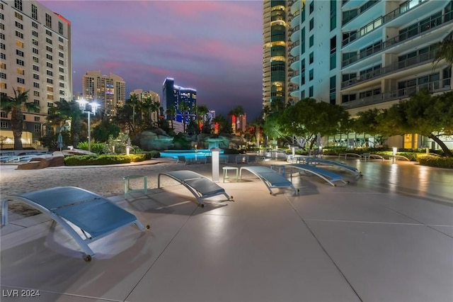 pool at dusk with a view of city