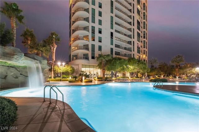 pool at dusk with pool water feature