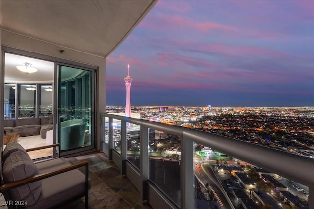 balcony at dusk with a view of city