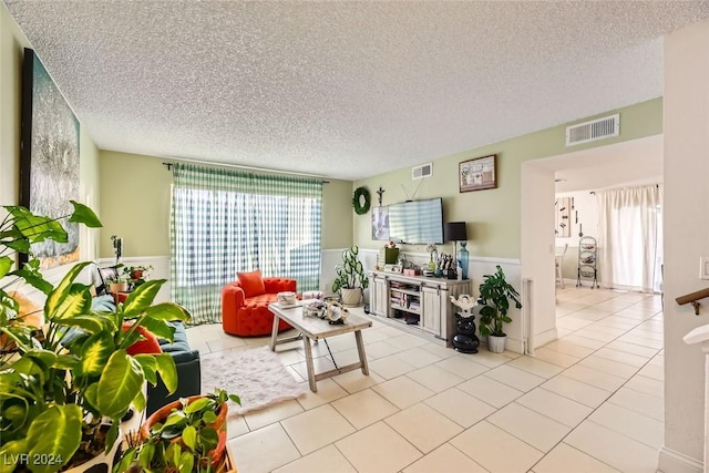 tiled living room with a textured ceiling