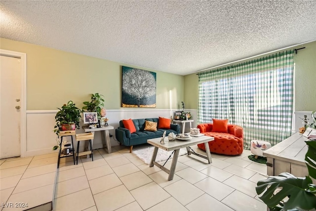 living room with light tile patterned floors and a textured ceiling