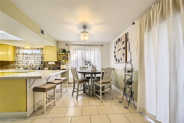 dining area with sink and light tile patterned flooring