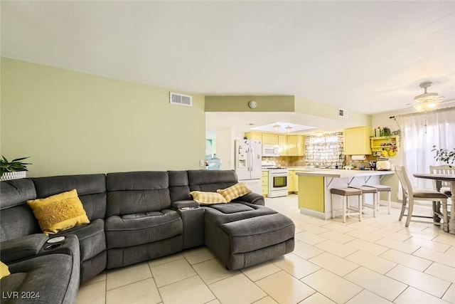 living room with light tile patterned floors and ceiling fan