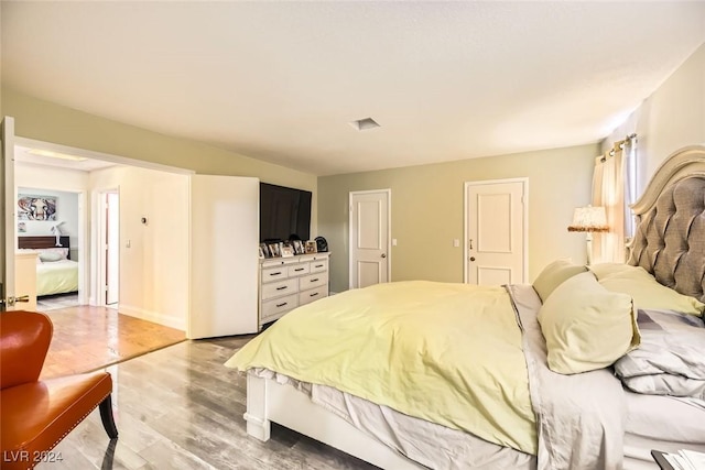 bedroom with hardwood / wood-style floors