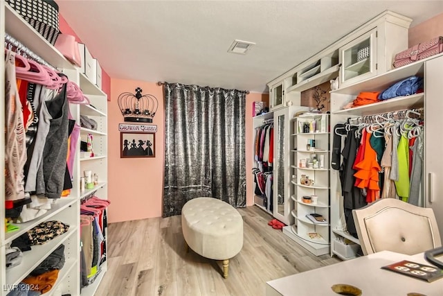 spacious closet featuring light hardwood / wood-style floors