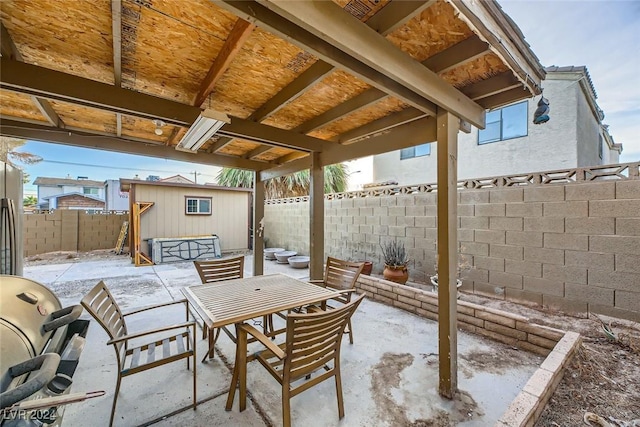 view of patio featuring a storage unit