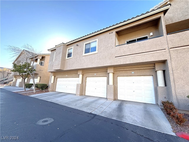 multi unit property featuring a garage
