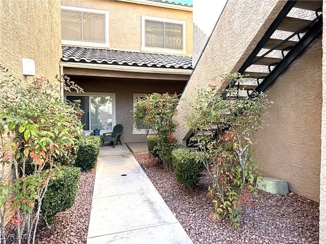 view of exterior entry with a patio