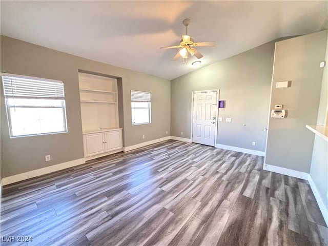 interior space with hardwood / wood-style floors, built in features, ceiling fan, and lofted ceiling