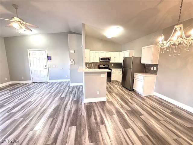 kitchen featuring white cabinets, stainless steel appliances, dark wood-type flooring, and lofted ceiling