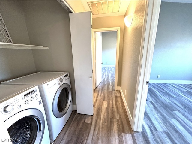 laundry area with washing machine and clothes dryer and dark hardwood / wood-style floors
