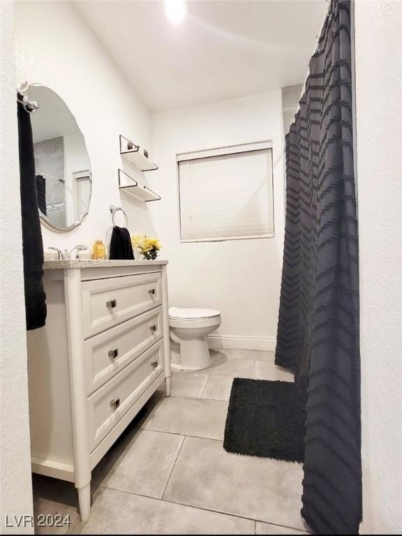 bathroom with tile patterned floors, vanity, toilet, and a shower with curtain