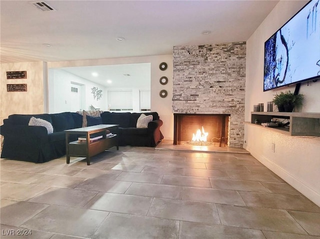 living room with a stone fireplace