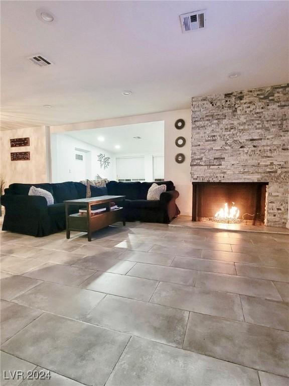 living room featuring a stone fireplace