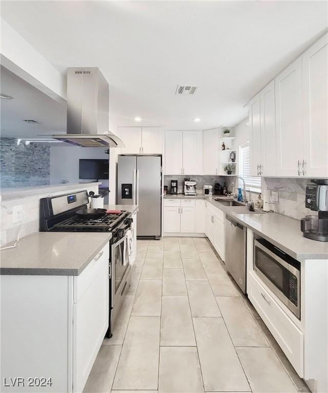 kitchen with white cabinets, stainless steel appliances, extractor fan, and tasteful backsplash