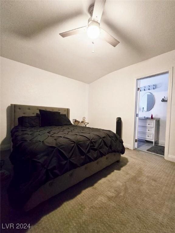 carpeted bedroom with ceiling fan, lofted ceiling, and connected bathroom