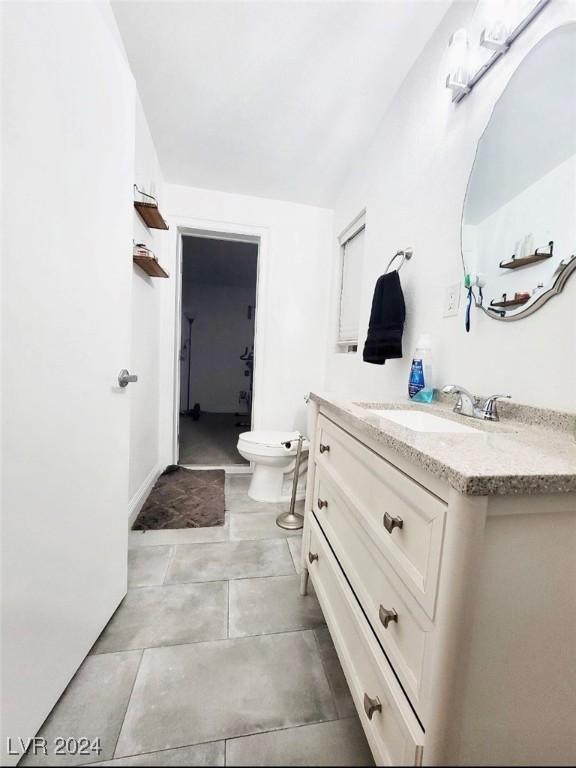 bathroom with vanity, vaulted ceiling, and toilet