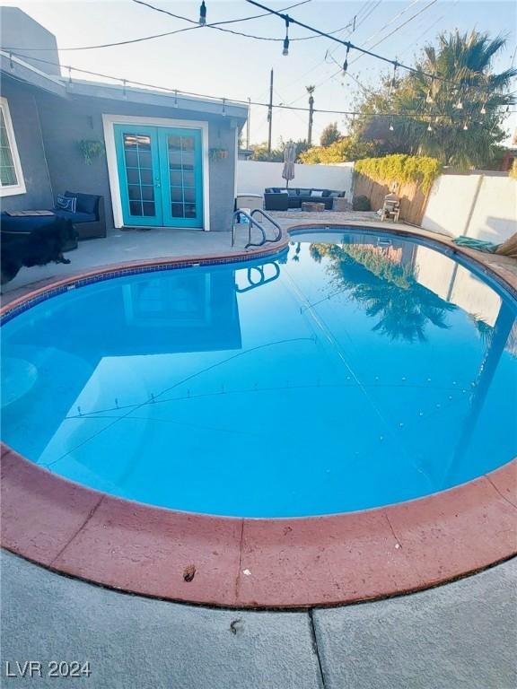 view of pool featuring french doors