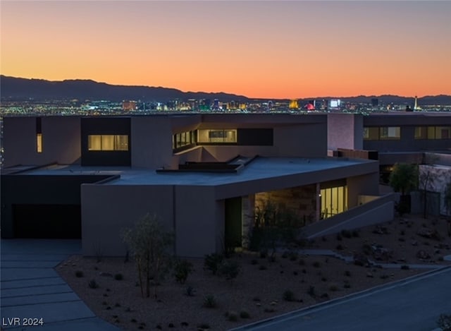 back house at dusk featuring a mountain view