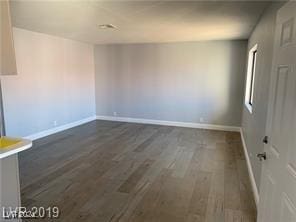 empty room featuring dark wood-type flooring