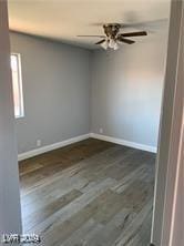 empty room with dark hardwood / wood-style flooring