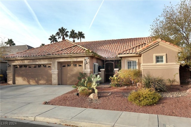 mediterranean / spanish-style home with a garage