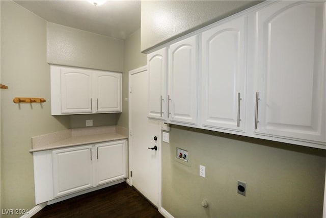 clothes washing area featuring washer hookup, electric dryer hookup, dark hardwood / wood-style flooring, and cabinets