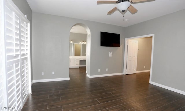 spare room featuring ceiling fan and dark wood-type flooring