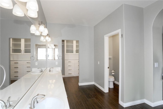 bathroom featuring hardwood / wood-style flooring, vanity, and toilet