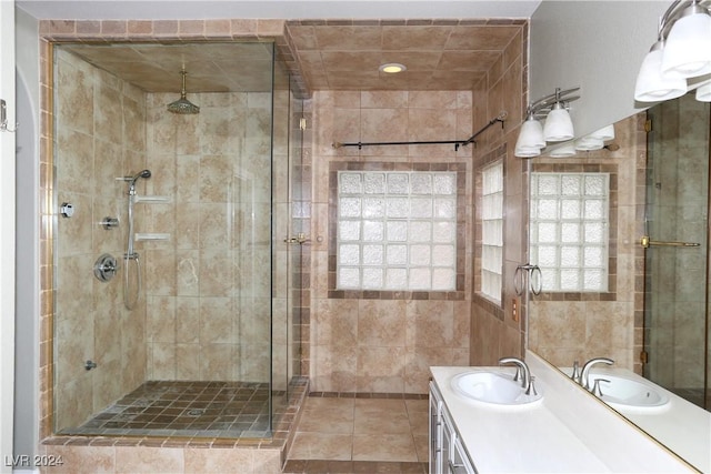 bathroom with tile patterned flooring, vanity, and a shower with shower door