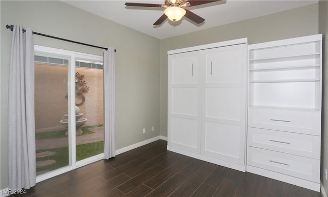 unfurnished bedroom featuring access to outside, dark hardwood / wood-style floors, and ceiling fan