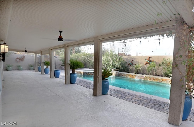 view of swimming pool featuring an in ground hot tub, a patio, and pool water feature