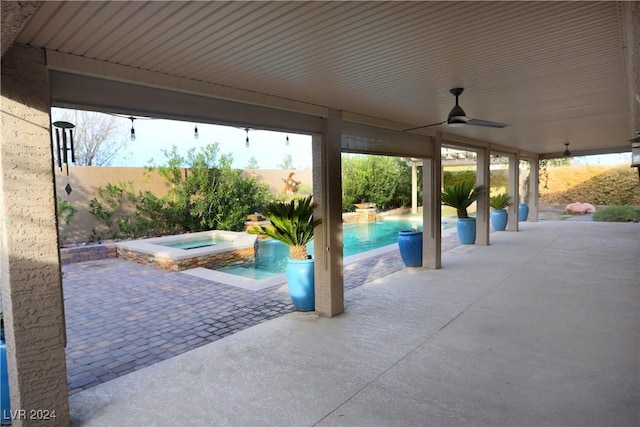 view of patio featuring ceiling fan and a swimming pool with hot tub