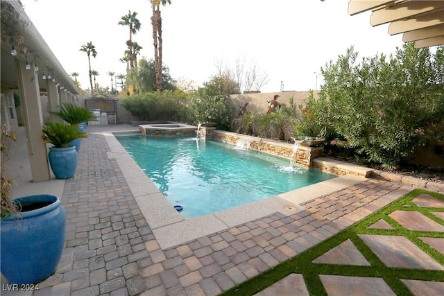 view of swimming pool featuring pool water feature, an in ground hot tub, and a patio