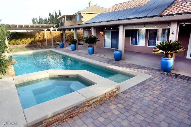 view of pool with an in ground hot tub