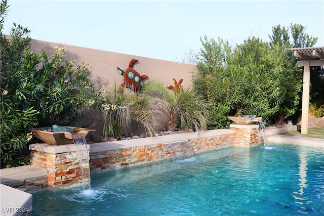 view of swimming pool with pool water feature