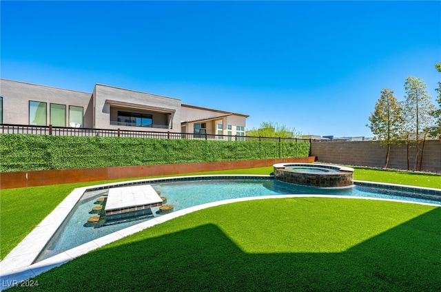 view of swimming pool with an in ground hot tub and a yard