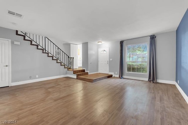 unfurnished living room featuring wood-type flooring