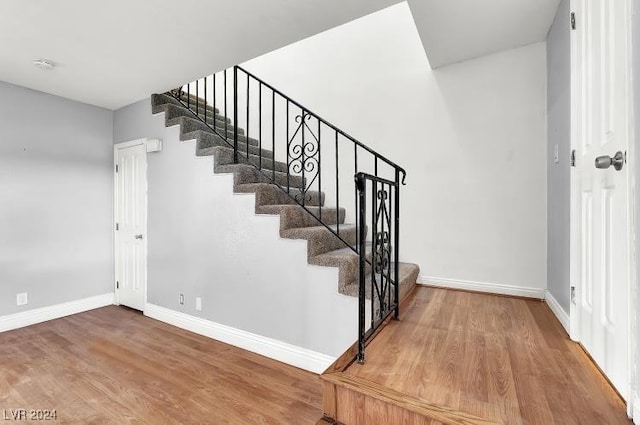 staircase featuring hardwood / wood-style floors