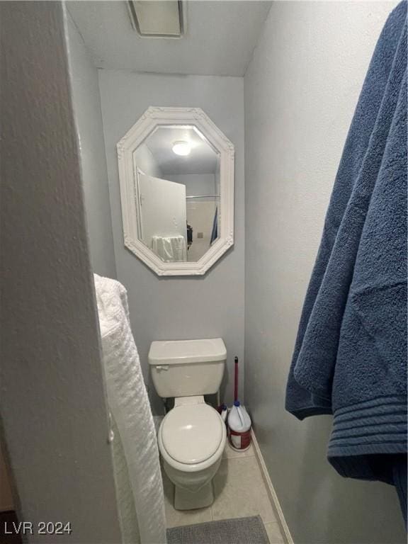 bathroom with tile patterned flooring and toilet