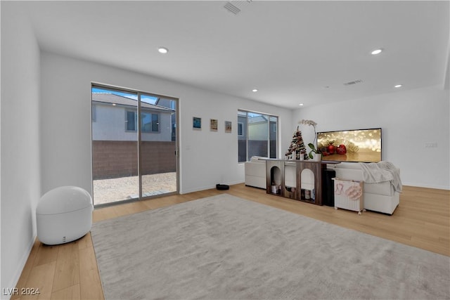 living room with a wealth of natural light and light wood-type flooring