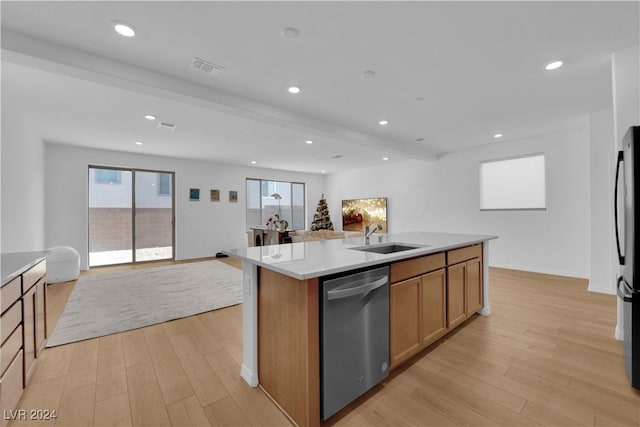 kitchen with a center island with sink, stainless steel appliances, light wood-type flooring, and sink