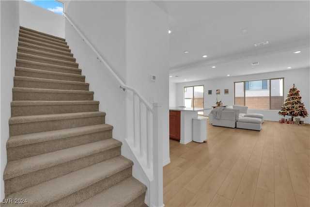 staircase with hardwood / wood-style flooring