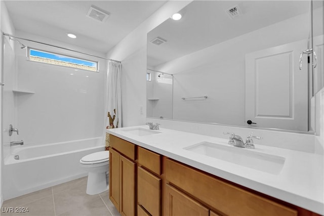 full bathroom with tile patterned floors, vanity, shower / tub combo, and toilet