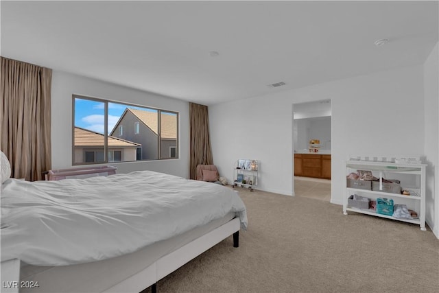 carpeted bedroom with ensuite bath