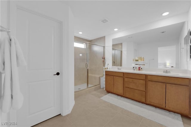 bathroom with tile patterned flooring, vanity, and a shower with shower door