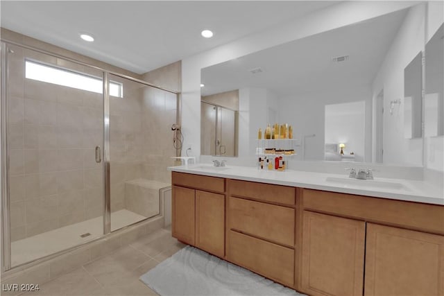 bathroom with tile patterned floors, vanity, and walk in shower