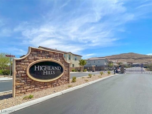 community sign with a mountain view