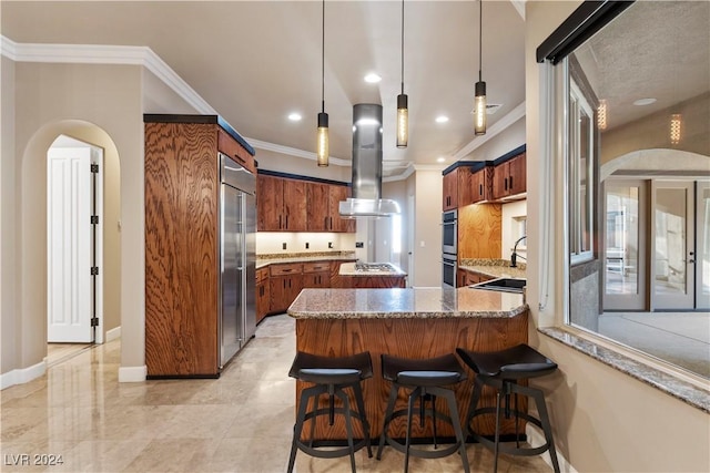 kitchen with appliances with stainless steel finishes, ornamental molding, ventilation hood, decorative light fixtures, and stone counters