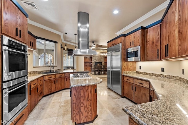 kitchen featuring built in appliances, a center island, crown molding, and island range hood